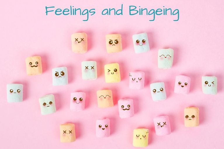 Pink background with pastel coloured marshmallows with faces